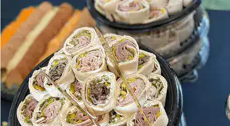 Delicious assorted wraps featuring fresh meats, cheeses, and vegetables, perfect for catering and special events.