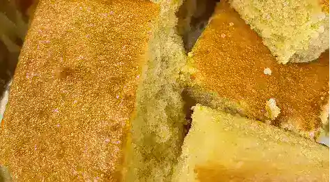 Freshly baked homemade cornbread slices with a golden crust, perfect for soul food meals and catering events.