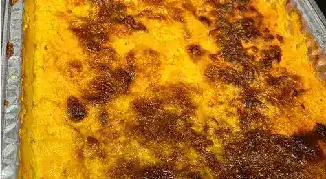 Delicious homemade baked macaroni and cheese with a golden, crispy top, perfect for comfort food lovers and catering events.