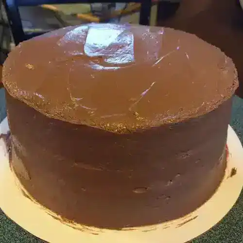 Delicious caramel cake with smooth, glossy caramel frosting, perfect for special occasions or desserts. Crafted with rich flavors and moist layers, showcasing expert baking and attention to detail.