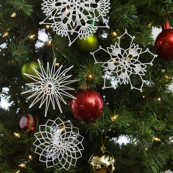 A starburst-inspired crochet snowflake pattern by Red Heart, featuring metallic yarn for a glimmering touch to holiday decor.