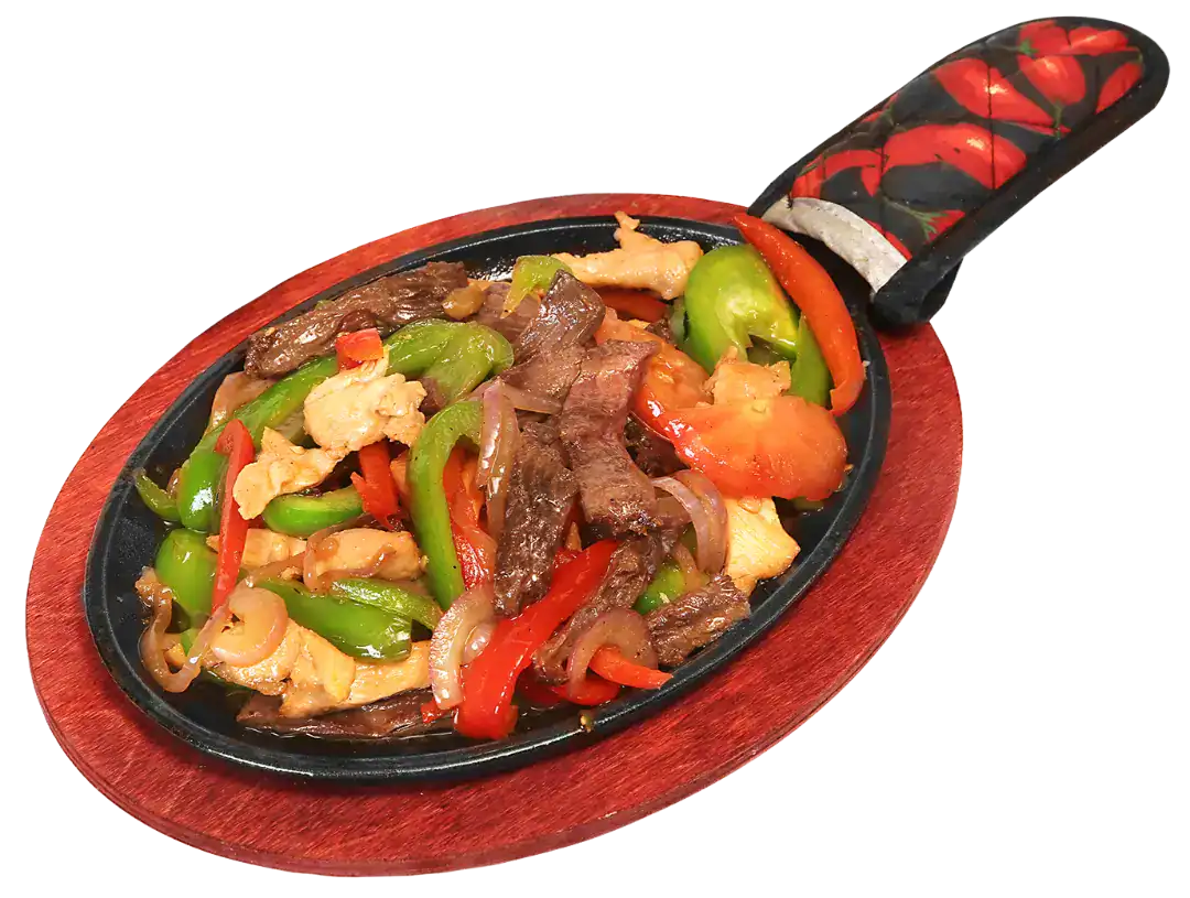 Colorful fajitas mixtas with beef, peppers, and onions served on a sizzling skillet.