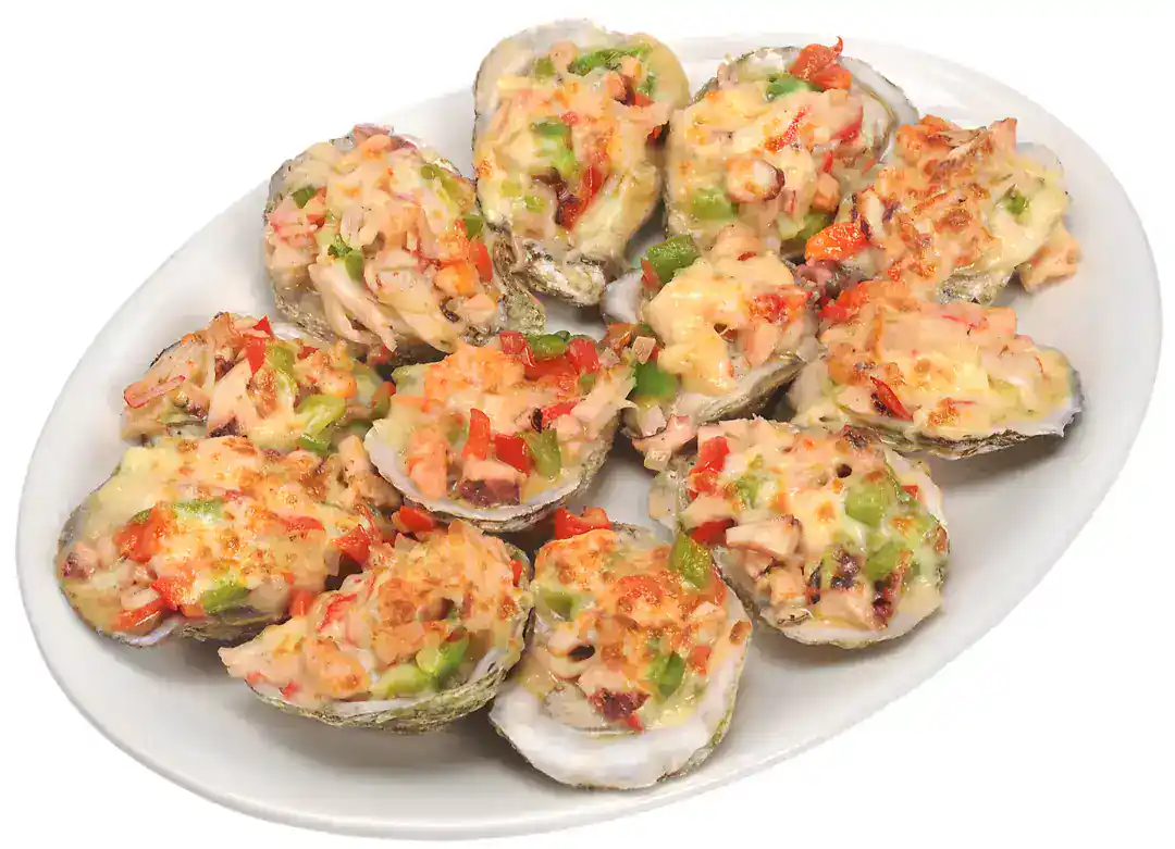 Ostiones gratinados on a white plate with cheese and vegetables.