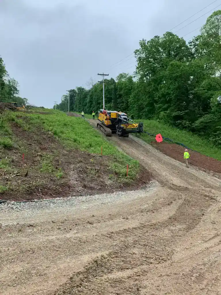 High voltage transmission line installation in Southern Ohio with construction equipment and workers.