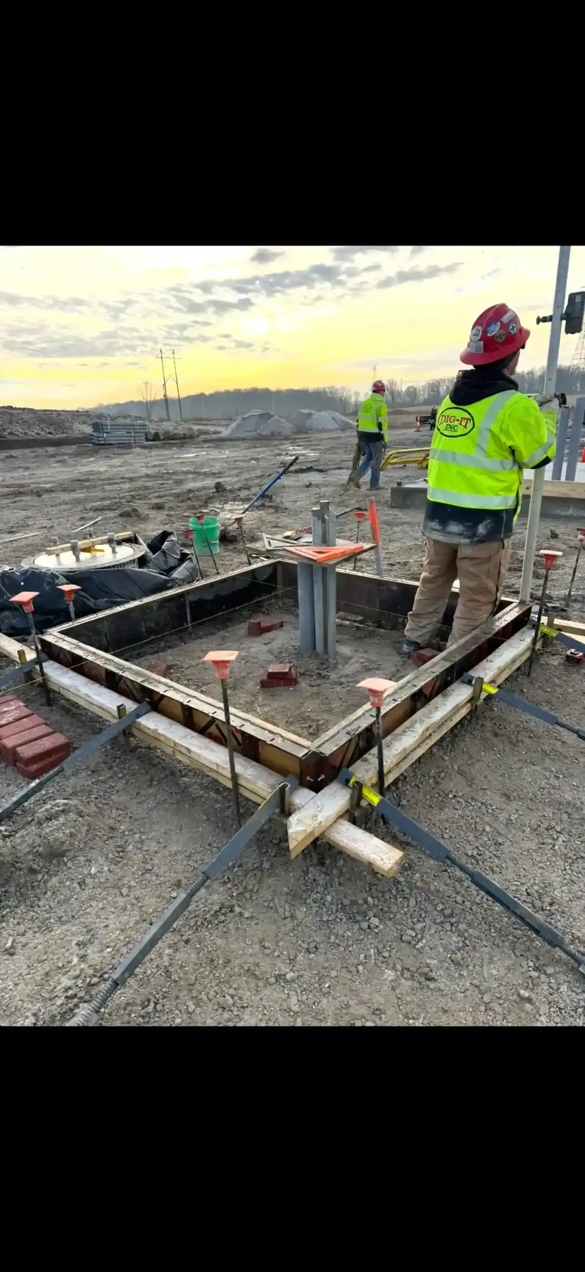 Construction workers installing flatwork pad foundations for utility infrastructure.