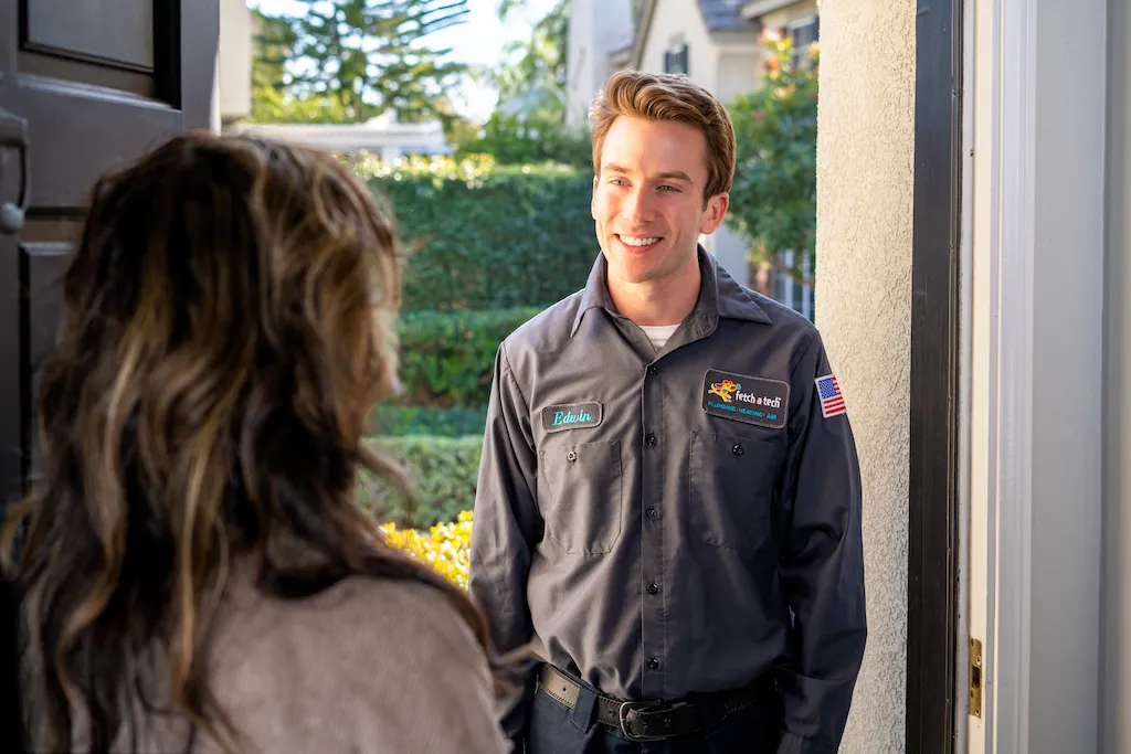 A friendly Fetch‑A‑Tech technician greets a homeowner at her Las Vegas residence, bringing professional service and peace of mind on a bright, sunny day.