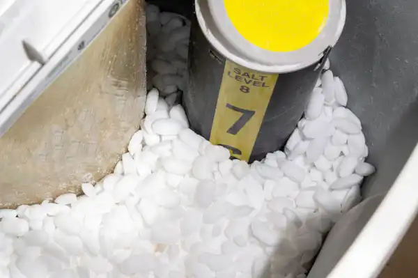 A water softener brine tank in a Las Vegas home, filled with clean salt pellets. The helpful salt level indicator shows the number 7, making it easy for customers to keep their system running smoothly. This simple step helps ensure continued comfort and great-tasting water—just another way Fetch‑A‑Tech’s family-owned team supports our Las Vegas neighbors.