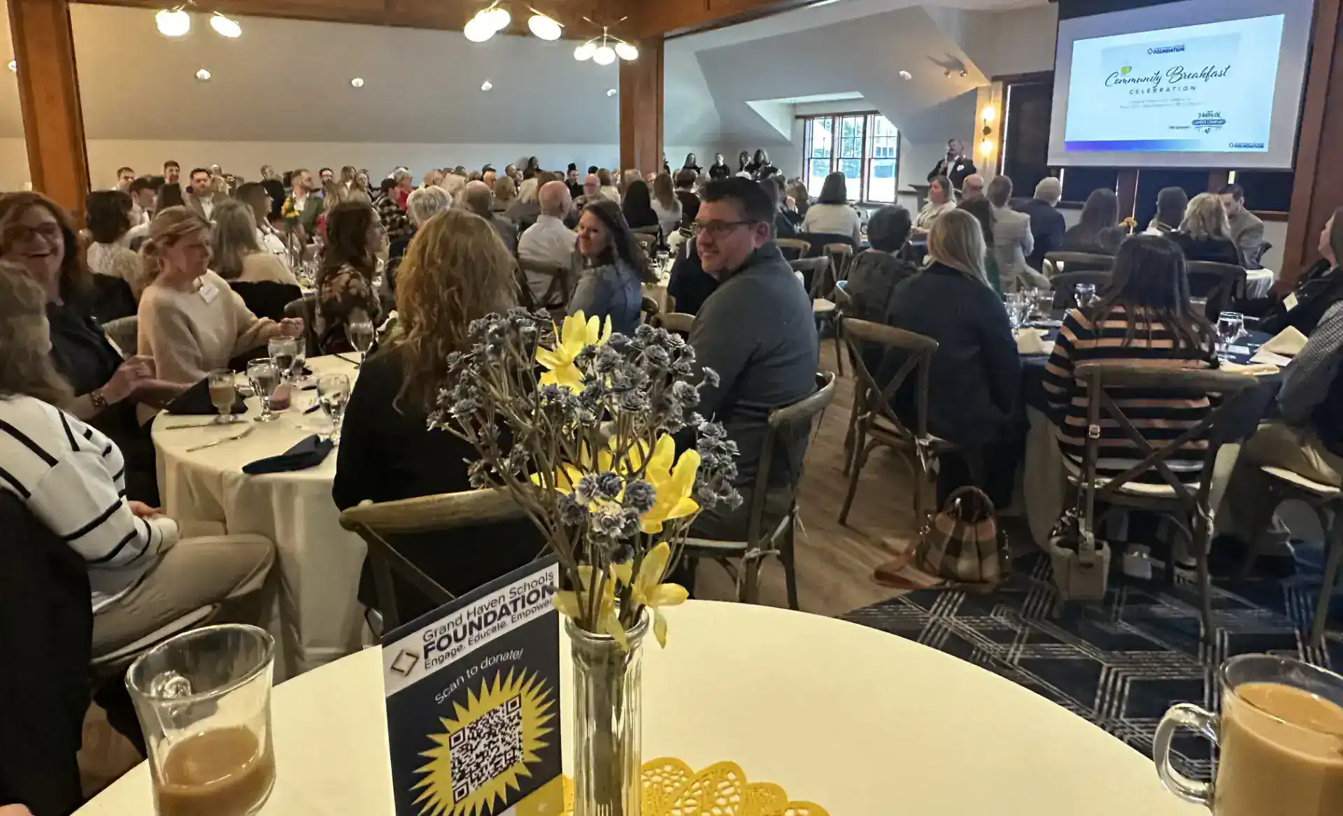 Attendees at GHSF conference seated at tables in a large hall.