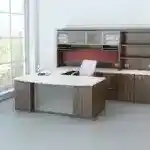 Contemporary office desk with storage cabinets and a white chair near a large window.