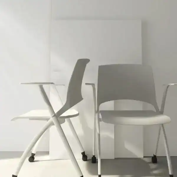 Two contemporary office chairs in a minimalistic, well-lit workspace.