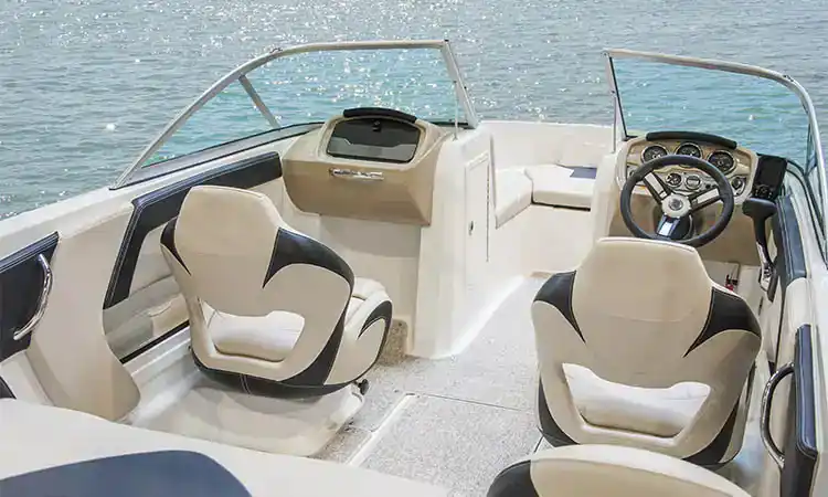 Modern boat cockpit with comfortable seating and navigation controls.