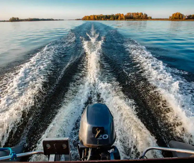 An exciting speedboat racing scene on calm water with a powerful motor and wake trails.