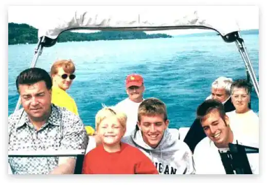 Family enjoying boating on a scenic lake with a boat rental.