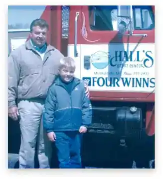 Family with truck at Hall's Sport Center dealership.