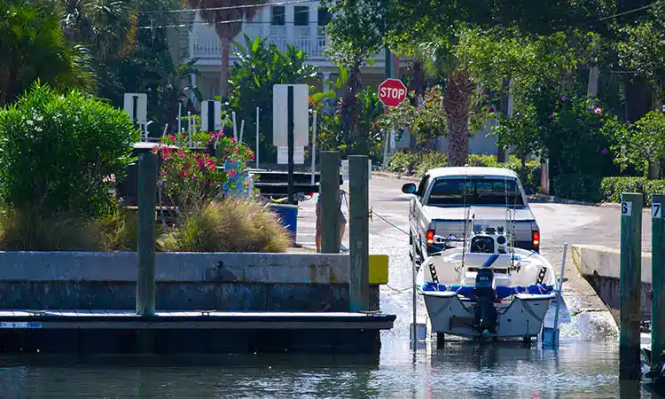 Sunny marina with boats and a dock area for water sports and boating activities.