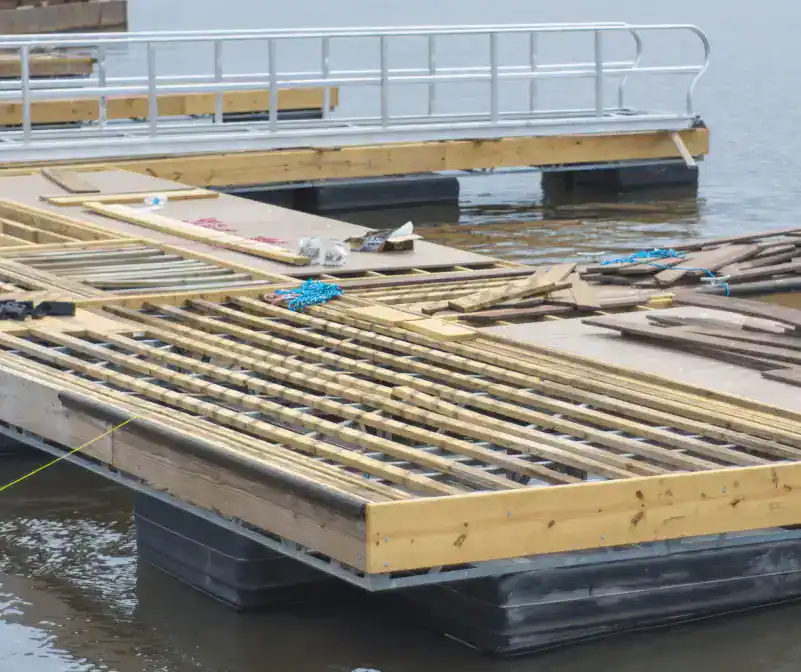Constructing a wooden dock on the water at Hall's Sport Center.
