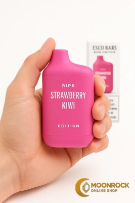 Hand holding a Strawberry Kiwi Esco Bars Ripe Edition disposable vape with box softly blurred in the background