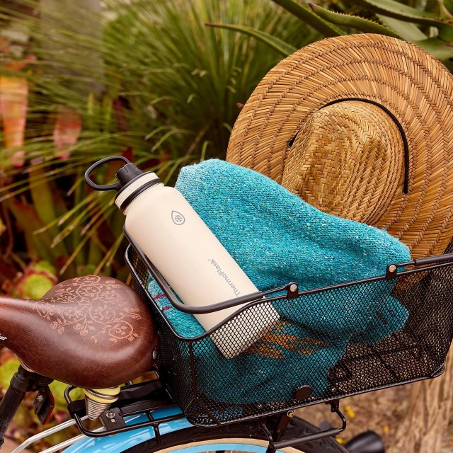 ThermoFlask thermos in a metal basket with a towel and sunhat