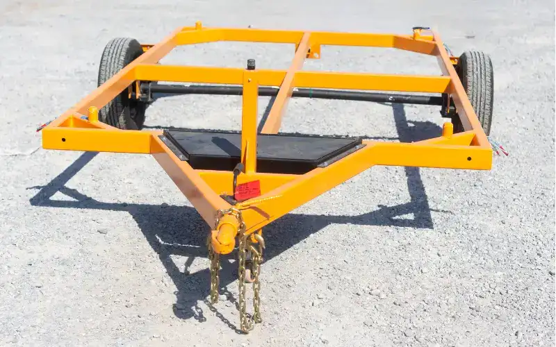 jeep transport trailer sitting in gravel parking lot