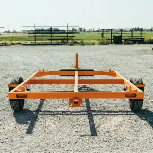 jeep transport trailer sitting in gravel parking lot with green pasture in the background
