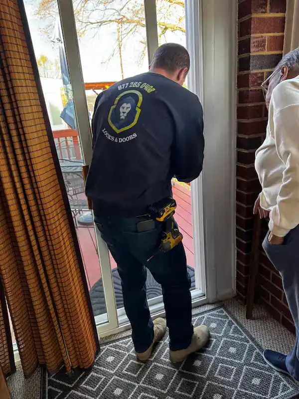 King Locksmith Bowie Md Technician Installs And Adjusts A Residential Sliding Glass Door Lock For Improved Home Security.