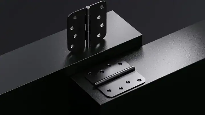 Close-up view of heavy-duty commercial door hinges mounted on a steel door and frame.