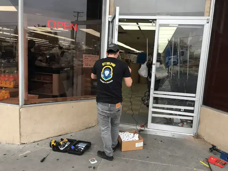 technician servicing a commercial storefront door in College Park, MD to restore secure