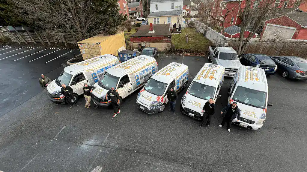 King Locksmith and Doors team in Rockville, Maryland standing with fully branded service vans