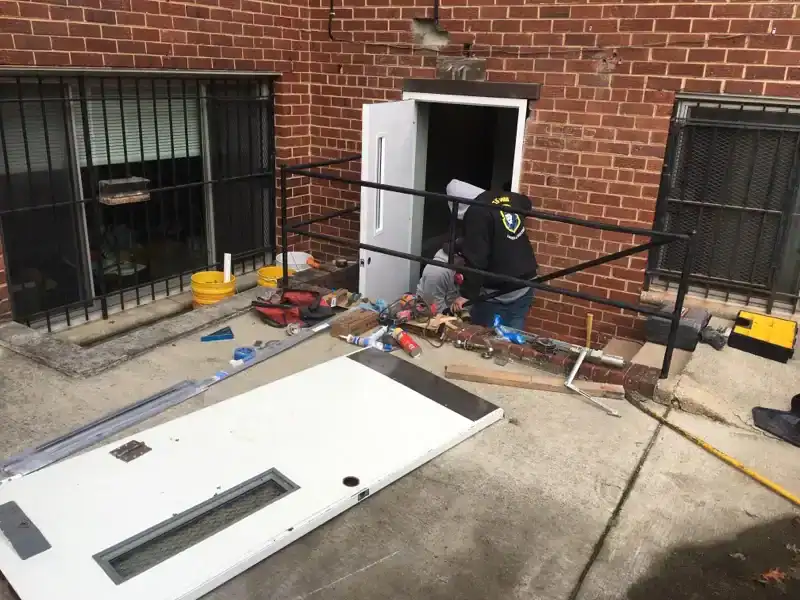King Locksmith technicians performing commercial door replacement at a Rockville, Maryland business, removing and installing a new exterior door system to restore secure access, proper alignment, and reliable daily operation