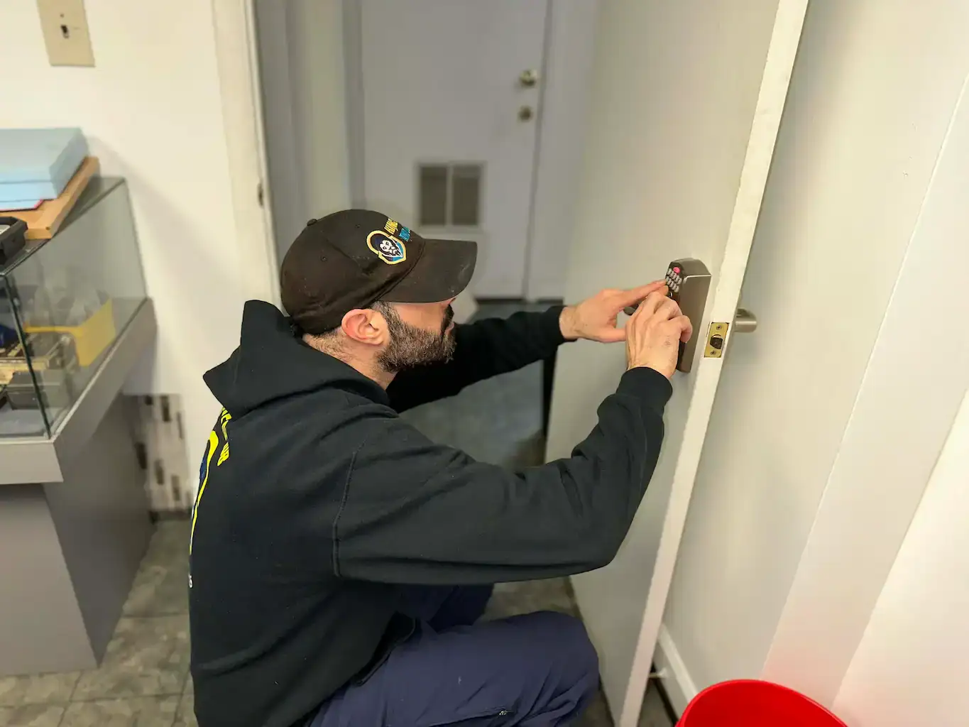Commercial locksmith technician from King Locksmith and Doors Inc installing keypad access control on office door in Severn MD for retail, warehouse, and multi-tenant building security