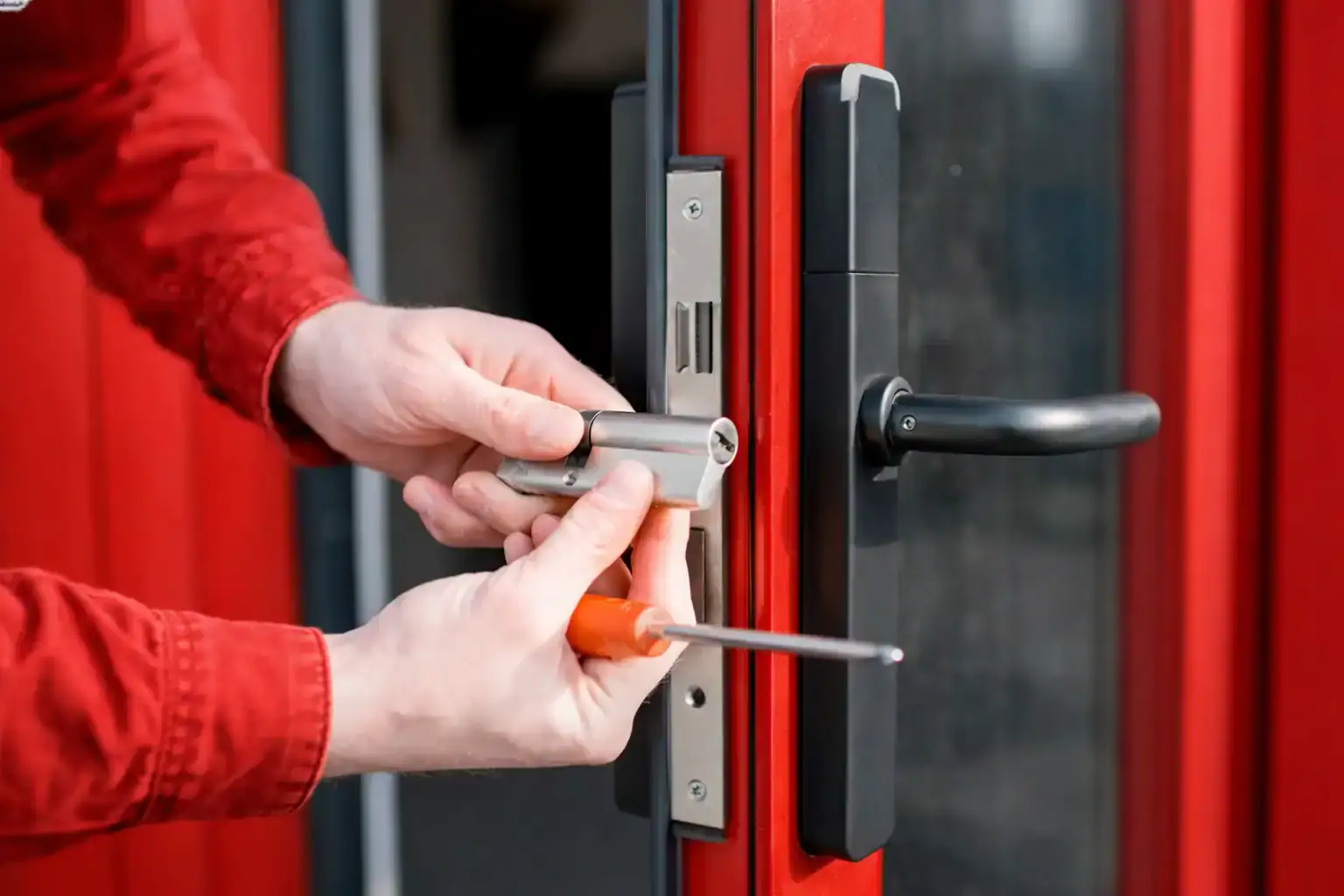 Professional lock rekey service in Silver Spring MD with locksmith installing door cylinder and recalibrating internal pins for secure access control.