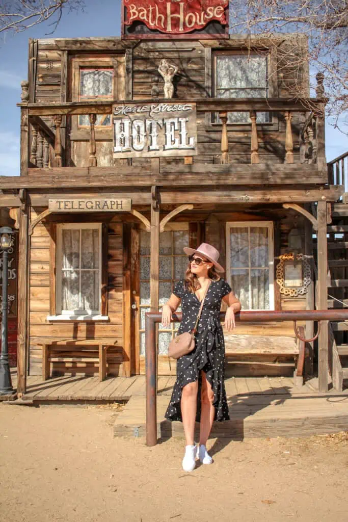 girl standing in front of pioneertown bath house