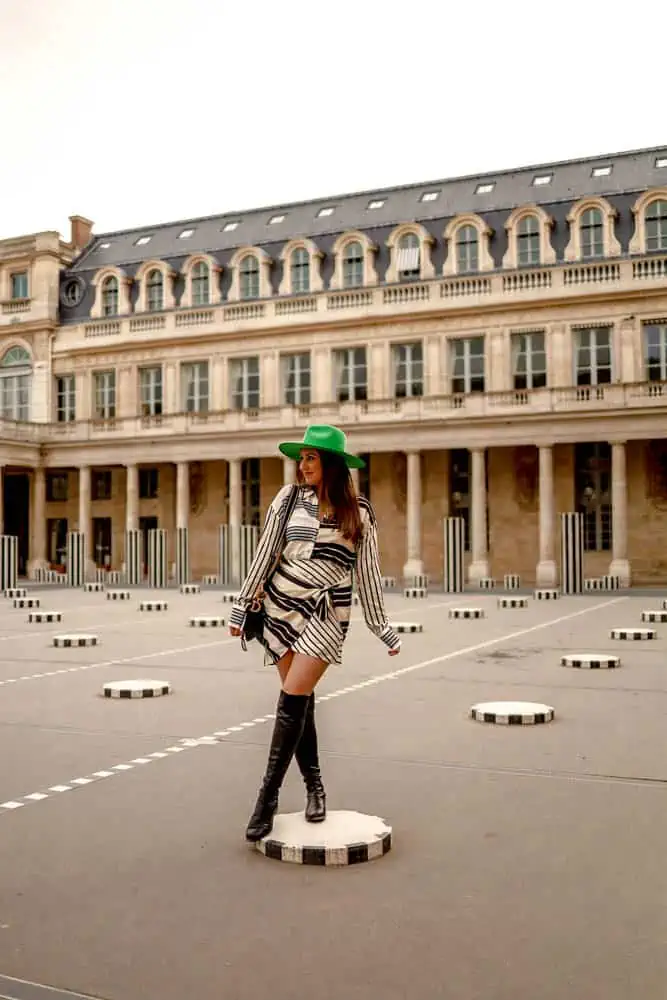 girl standing in courtyard of Les Deux Plateaux