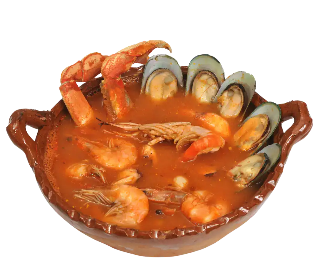 Seafood soup with shrimp, mussels, and crab in a clay bowl.