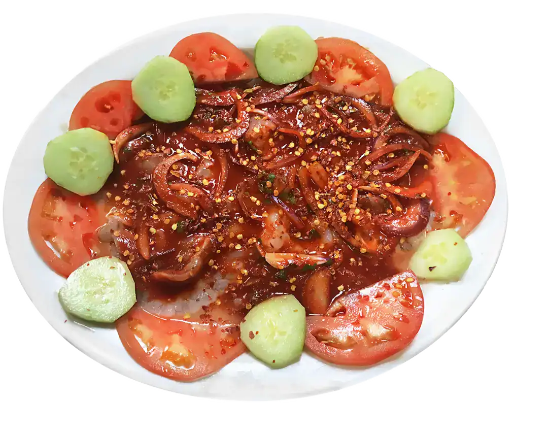 Spicy Camarones Aguachile Rojo with tomatoes and cucumber slices.