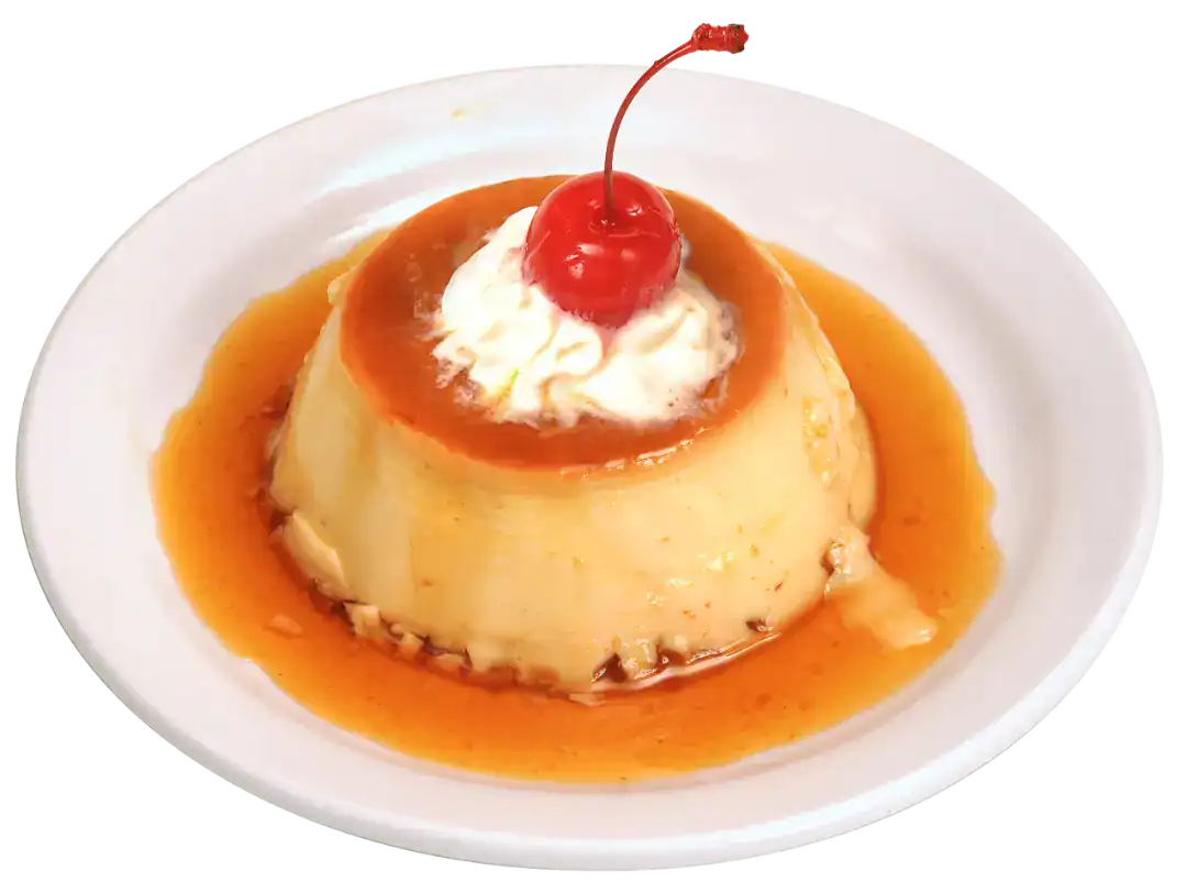 Delicious Flan Napolitano with caramel sauce and cherry topping.