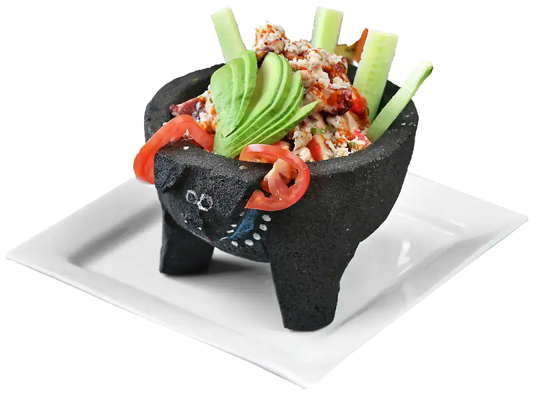 Traditional Mexican molcajete with fresh ingredients and toppings.
