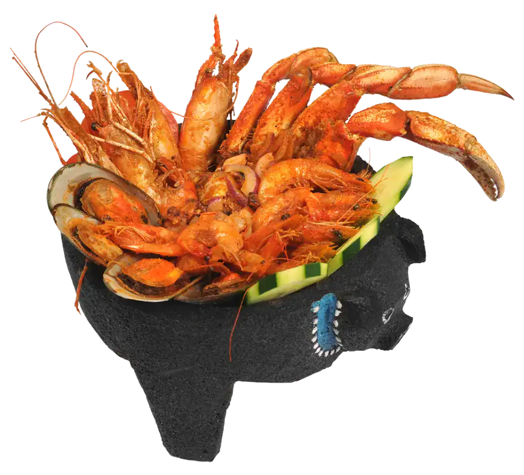 Seafood molcajete with shrimp, lobster, and crab served in a stone bowl.