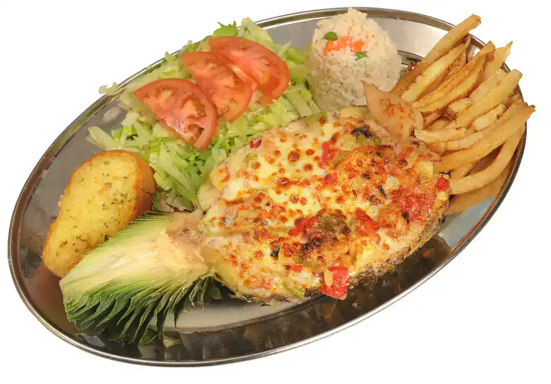 Piña Rellena dish with fries, salad, and rice on a metal plate.