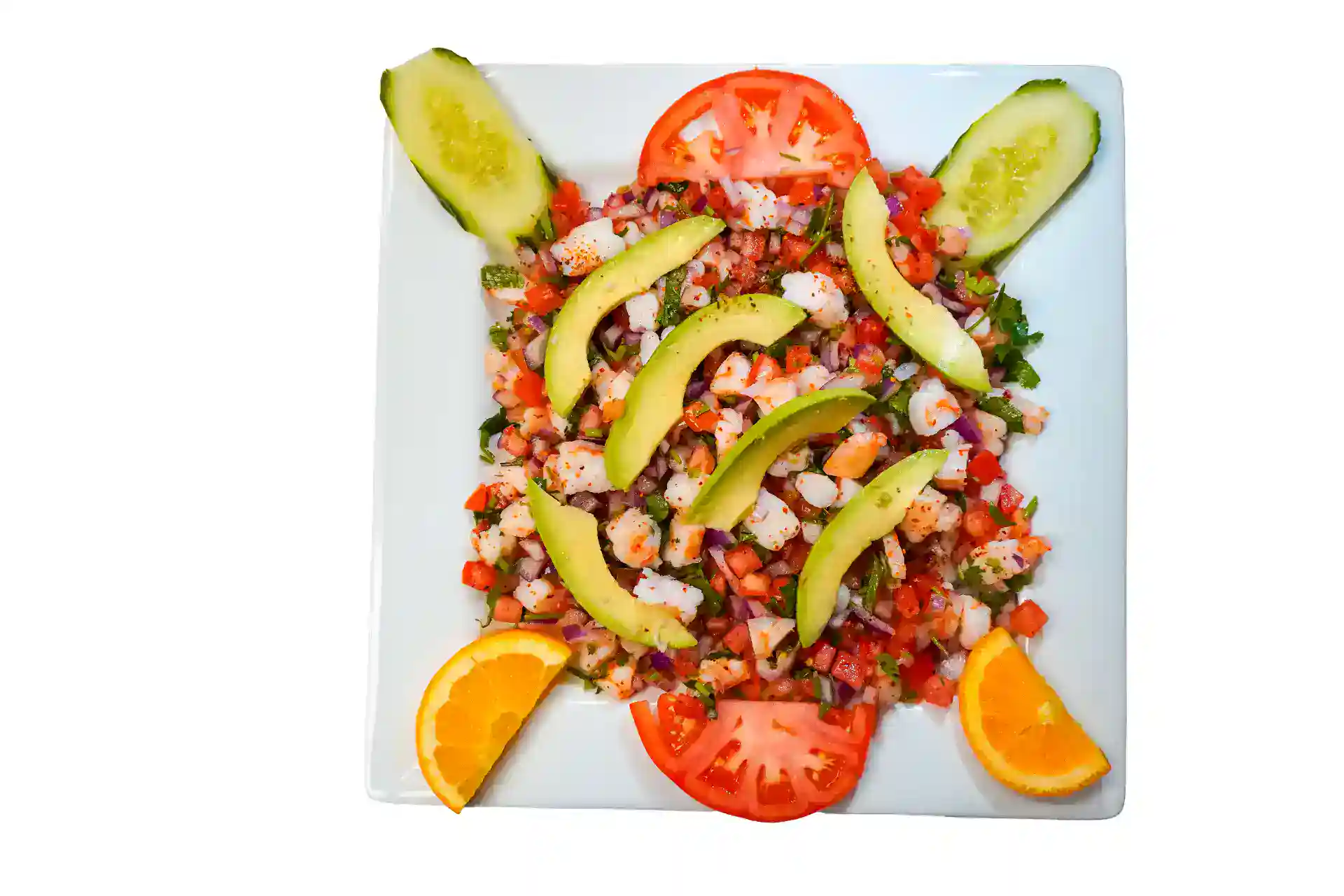 Colorful shrimp salad with cucumbers, tomatoes, and oranges on a white plate.