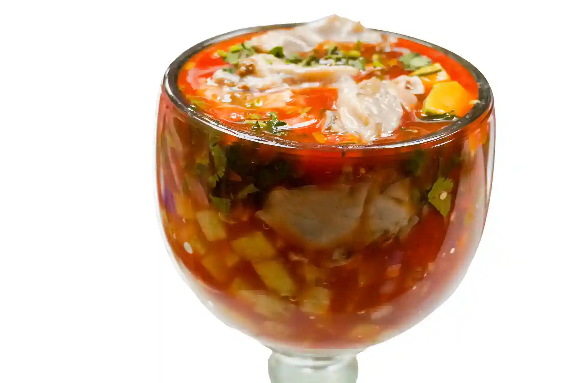 Chilled gazpacho soup with vegetables in a glass bowl.
