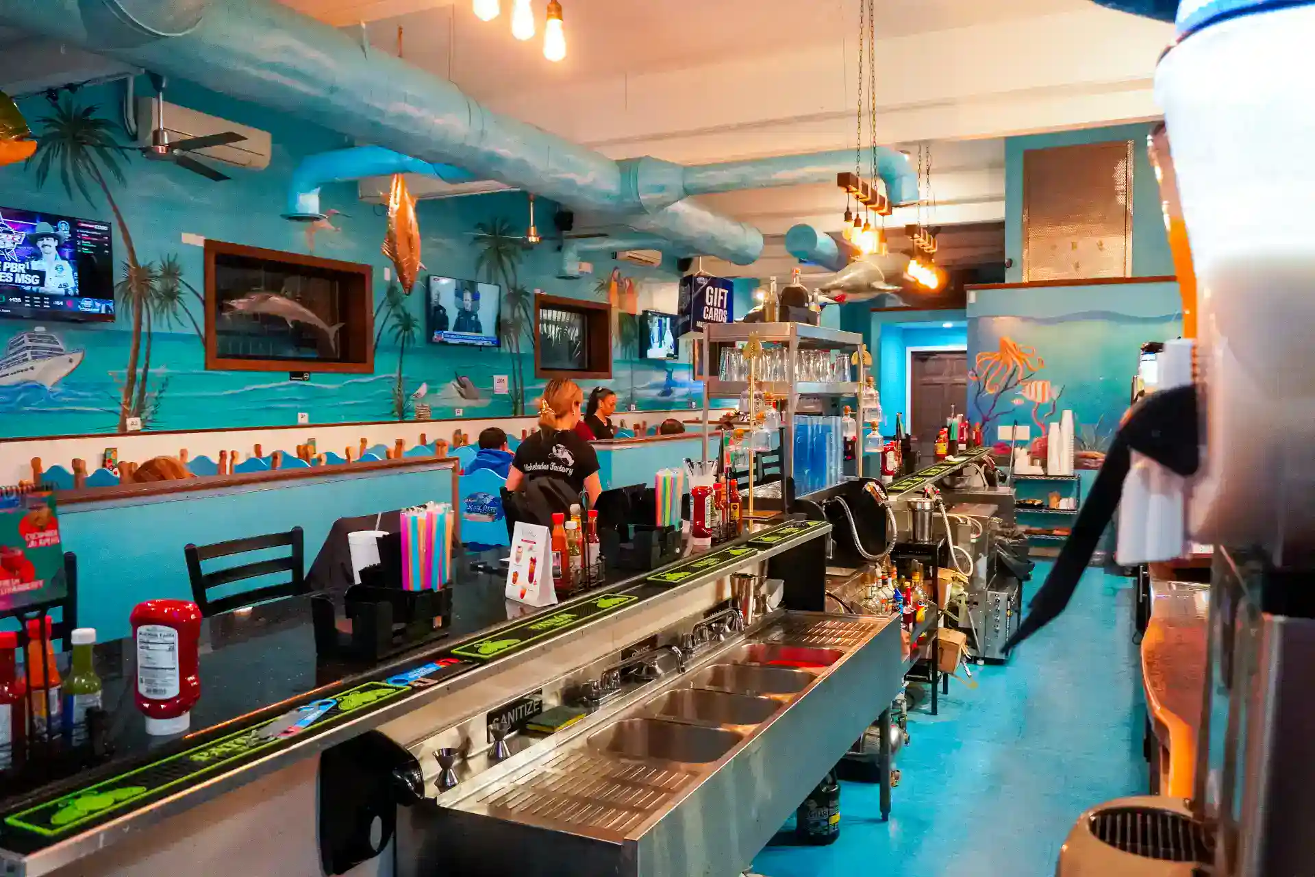 Colorful bar interior at Mi Lindo San Blas with tropical decor and lively atmosphere.