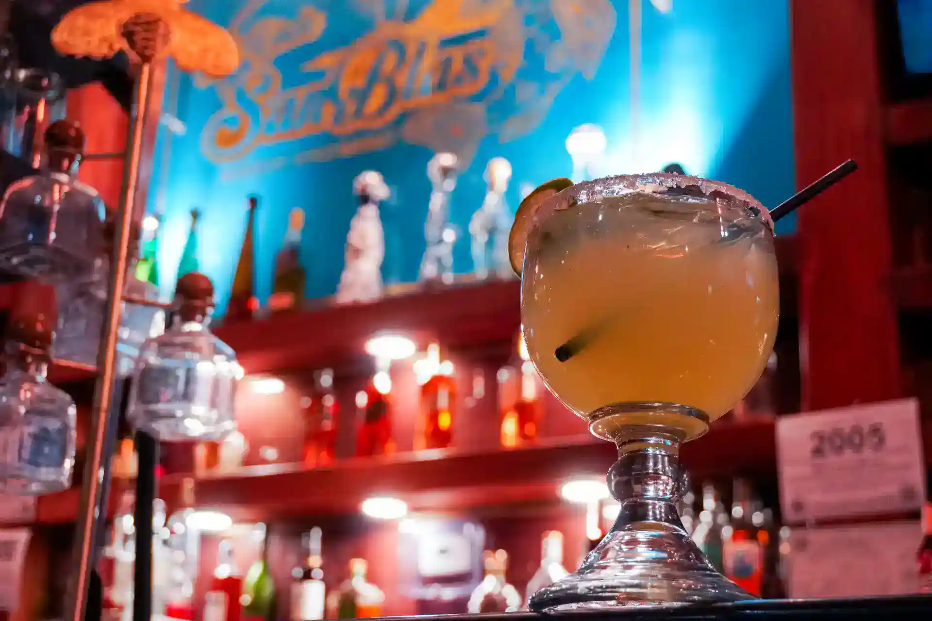 Refreshing San Blas cocktail served in a glass with lime and cherry garnish.