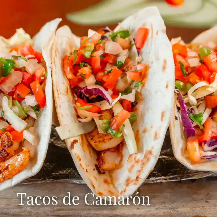 Shrimp tacos with colorful vegetable salsa, served on soft tortillas for a delicious seafood meal.