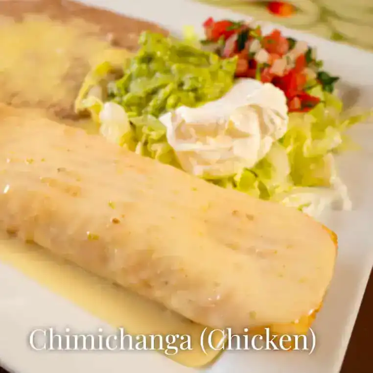 Delicious chimichanga with chicken, served with fresh toppings and creamy sauce.