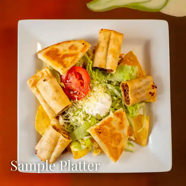 Delicious grilled spring rolls served on a fresh salad with tomato and lettuce.