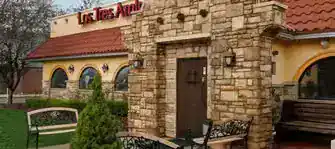 Exterior of a renovated restaurant building with stone accents and welcoming entrance.