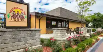 New restaurant building with outdoor seating and landscaping.