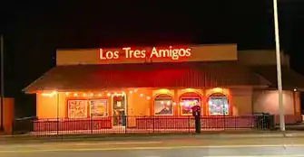 Night view of Los Tres Amigos restaurant with illuminated signage.