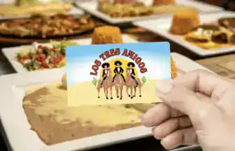 Logo of "Los Tres Amigos" featuring three cartoon cowboys in front of a desert background.